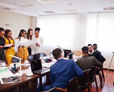 Diverse business people on a meeting at round table. Diverse business people on a meeting at round table.