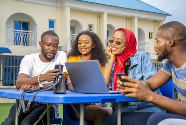 A group of young African people hanging out in an outdoor cafe