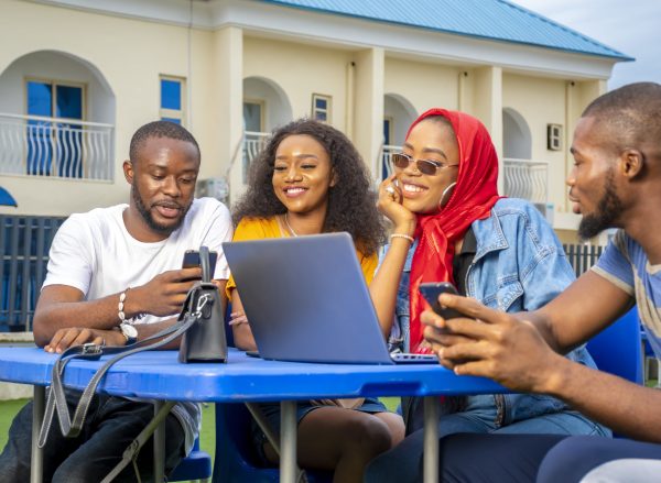 A group of young African people hanging out in an outdoor cafe