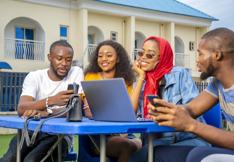 A group of young African people hanging out in an outdoor cafe