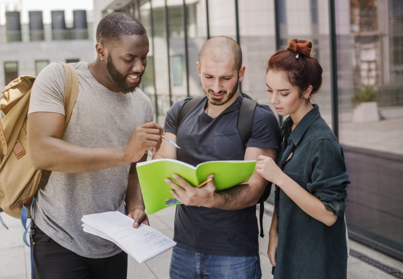 people-standing-with-papers-outdoors