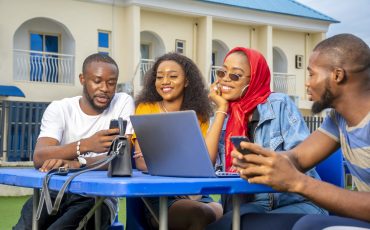 Group of young African people hanging out in an outdoor cafe A group of young African people hanging out in an outdoor cafe